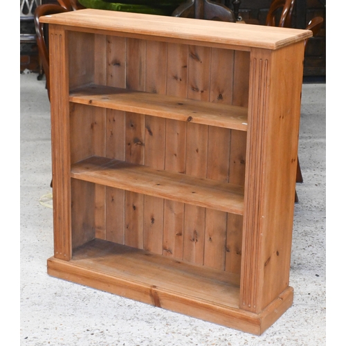 59 - A pine low open bookcase, on a plinth base 91 cm w x 28 cm d x 100 cm h to/with a Laura Ashley two t... 