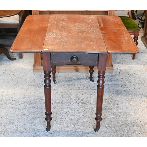 61 - # A Victorian mahogany Pembroke table, drawer to one end, raised on turned legs to brass castors 99 ... 