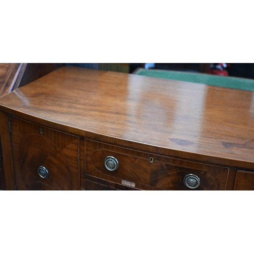 67 - A 19th century mahogany bowfront sideboard with central drawer flanked by cupboards, raised on taper... 