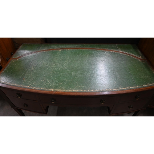 72 - An Edwardian mahogany bowfront writing table with gilt tooled green leather top and three drawers on... 