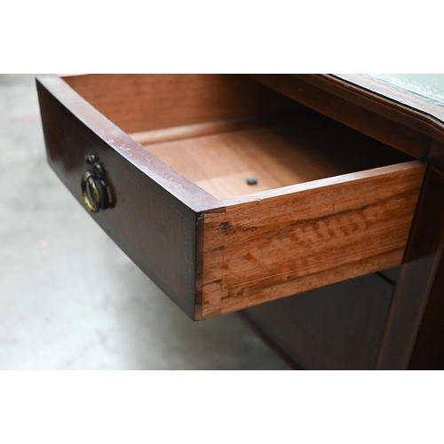 72 - An Edwardian mahogany bowfront writing table with gilt tooled green leather top and three drawers on... 