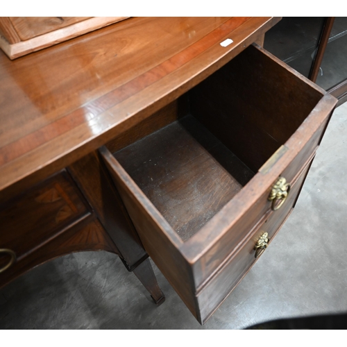 75 - An Edwardian inlaid mahogany Sheraton revival bowfront sideboard with cupboard and drawers with bras... 