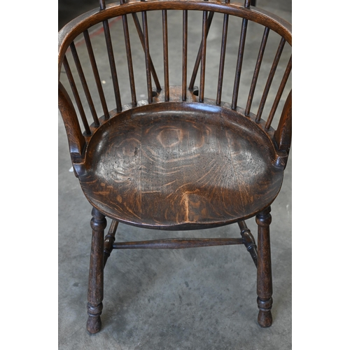 79 - An ash and elm spindle back Windsor chair with shaped circular seat and turned legs with stretchers,... 