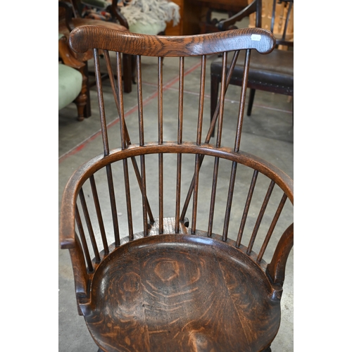 79 - An ash and elm spindle back Windsor chair with shaped circular seat and turned legs with stretchers,... 