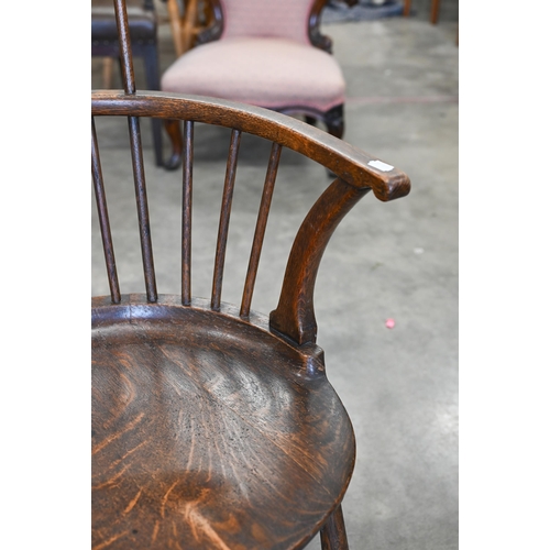 79 - An ash and elm spindle back Windsor chair with shaped circular seat and turned legs with stretchers,... 