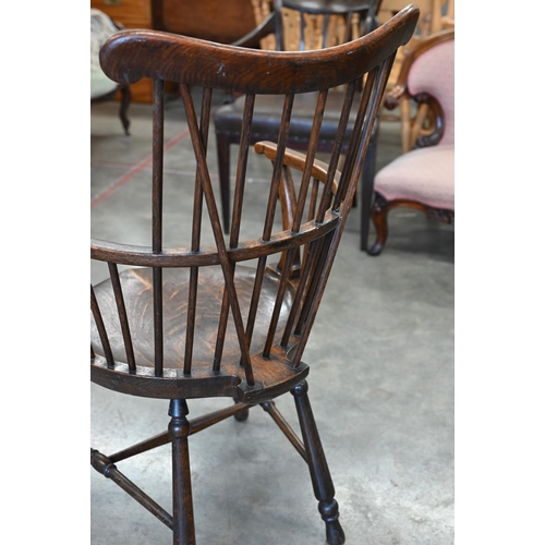 79 - An ash and elm spindle back Windsor chair with shaped circular seat and turned legs with stretchers,... 