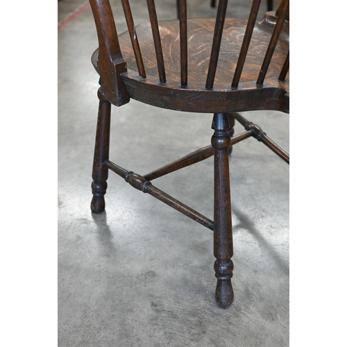 79 - An ash and elm spindle back Windsor chair with shaped circular seat and turned legs with stretchers,... 