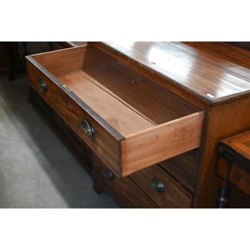 81 - A 19th century mahogany chest of four long graduating drawers with brass handles raised on bracket f... 