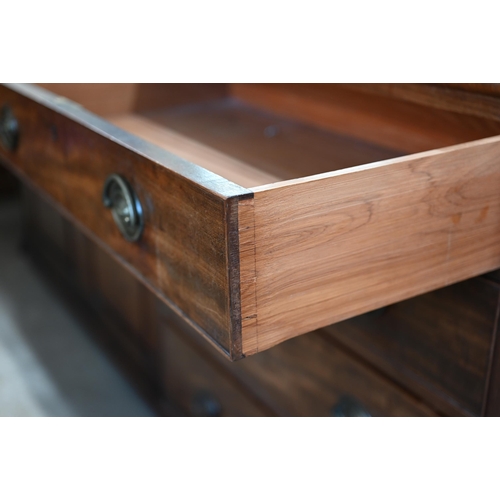 81 - A 19th century mahogany chest of four long graduating drawers with brass handles raised on bracket f... 