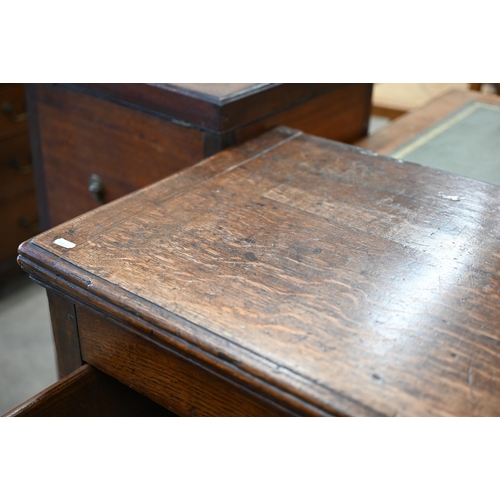 86 - A Georgian 18th century oak low dresser, the two drawers with brass handles over shaped fret-cut apr... 