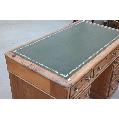 89 - An early 20th century small pine twin pedestal desk with tooled green leather top over nine drawers,... 