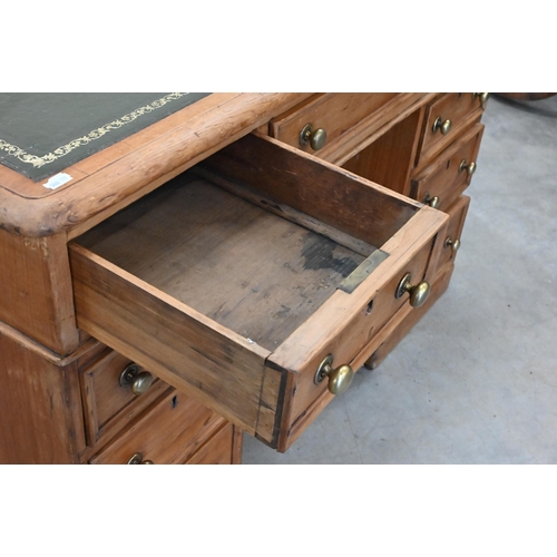 89 - An early 20th century small pine twin pedestal desk with tooled green leather top over nine drawers,... 