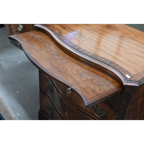 92 - A good quality Georgian style cross-banded mahogany serpentine front chest with brushing slide over ... 