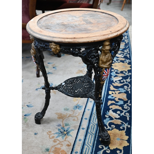 93 - A Victorian black and gilt (re-painted) cast iron Britannia table with later circular hardwood top, ... 