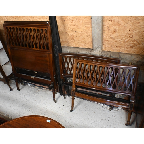 557 - A pair of antique lattice formed single bed frames, with iron side rails, both bear Heal & Son i... 