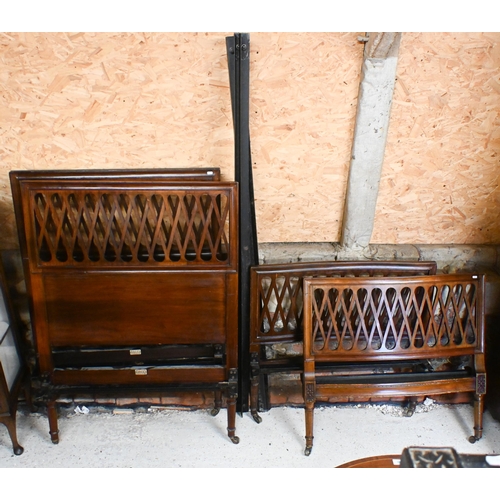 557 - A pair of antique lattice formed single bed frames, with iron side rails, both bear Heal & Son i... 