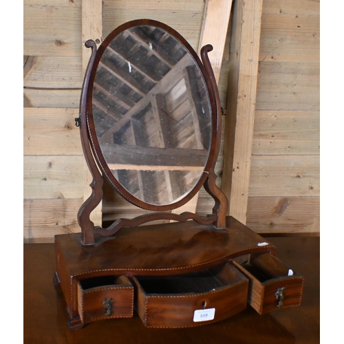 559 - A Regency chequer strung satinwood oval toilet mirror raised on a serpentine platform base