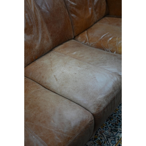 560 - A modern antiqued tan leather three seater sofa to/with a matching two seat sofa, an armchair and ot... 