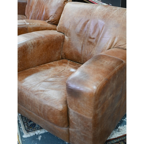 560 - A modern antiqued tan leather three seater sofa to/with a matching two seat sofa, an armchair and ot... 