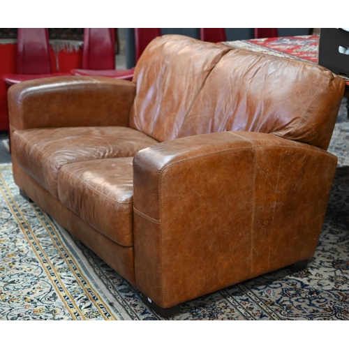 560 - A modern antiqued tan leather three seater sofa to/with a matching two seat sofa, an armchair and ot... 