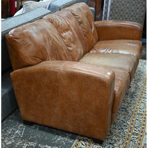 560 - A modern antiqued tan leather three seater sofa to/with a matching two seat sofa, an armchair and ot... 