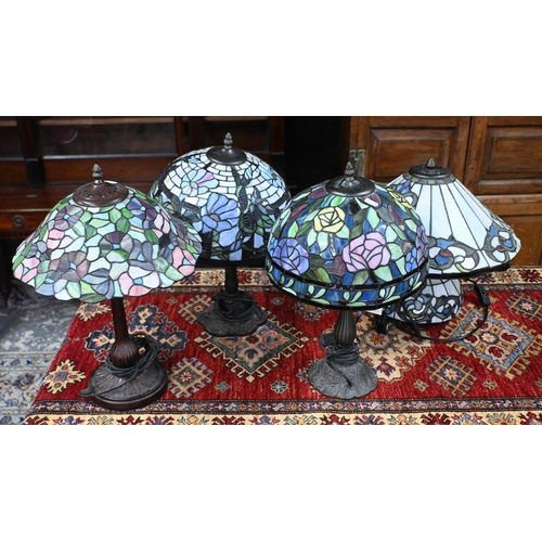 563 - Three Tiffany-style lamps with stained glass shades on Art Nouveau style organic metal bases, 48cm h... 