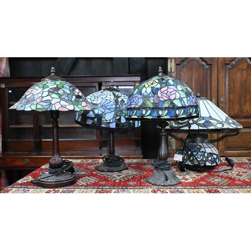 563 - Three Tiffany-style lamps with stained glass shades on Art Nouveau style organic metal bases, 48cm h... 