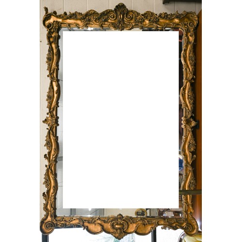 A large bevelled wall mirror in baroque style composite floral and foliate moulded frame, 220 cm h x 150 cm w