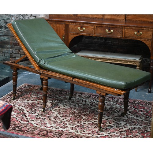 32 - A Victorian cane panelled campaign day bed, raised on turned legs to brass castors, with green leath... 