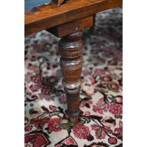 32 - A Victorian cane panelled campaign day bed, raised on turned legs to brass castors, with green leath... 