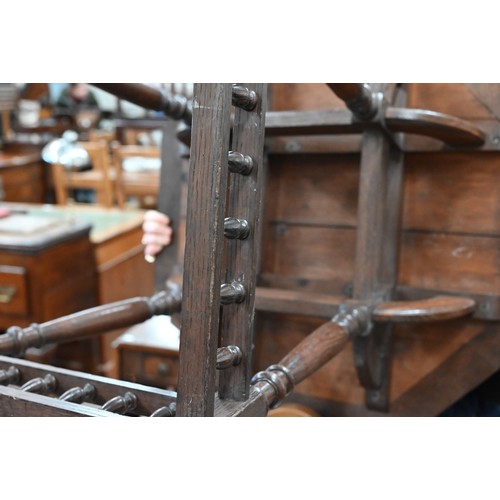 156 - An early 20th century oak and parquetry inlaid octagonal table on turned supports united by spindled... 