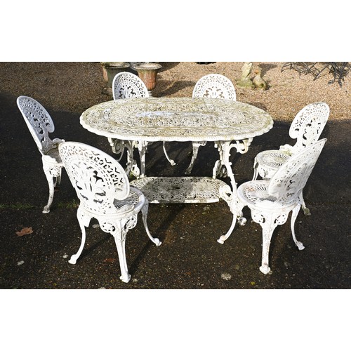 2 - Amended description A weathered Victorian style cast terrace dining table and six chairs set, umbrel... 