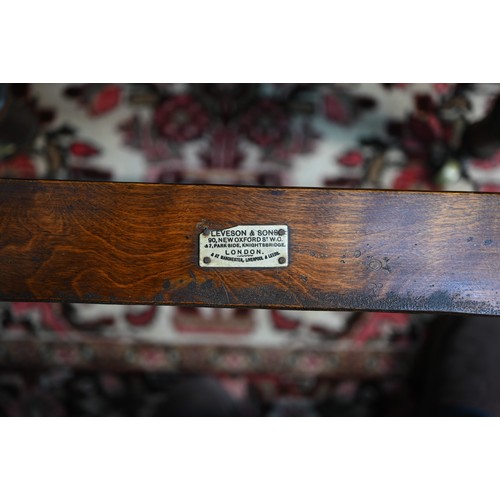 32 - A Victorian cane panelled campaign day bed, raised on turned legs to brass castors, with green leath... 