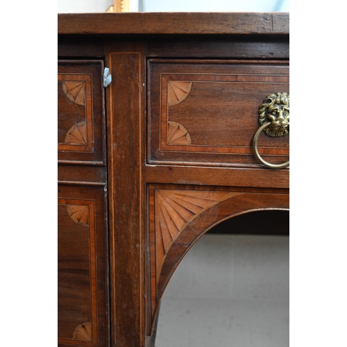 75 - An Edwardian inlaid mahogany Sheraton revival bowfront sideboard with cupboard and drawers with bras... 