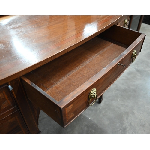 75 - An Edwardian inlaid mahogany Sheraton revival bowfront sideboard with cupboard and drawers with bras... 