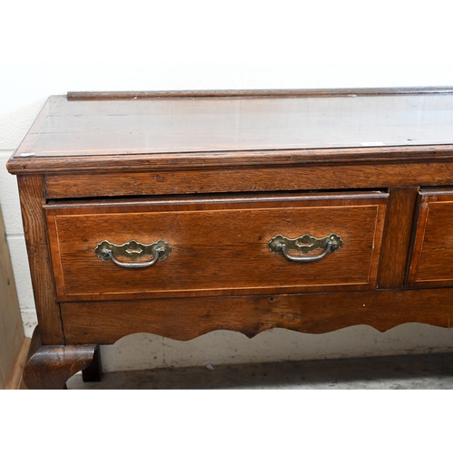 103 - A Georgian oak and box-wood strung low dresser with two drawers and shaped supports 136 cm w x 44 cm... 