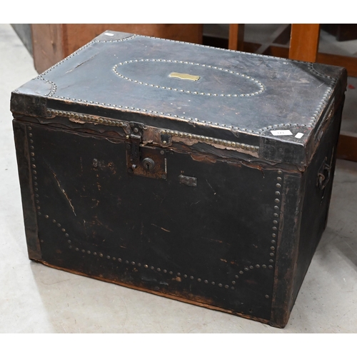 173 - An early/mid 19th century pine trunk covered in brass studded leather with side handles and ownershi... 