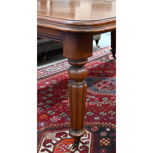 210 - A 19th century mahogany wind-out action extending dining table, the rounded rectangular top opening ... 