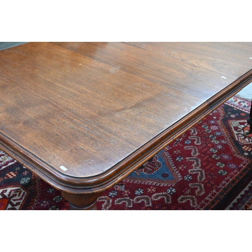 210 - A 19th century mahogany wind-out action extending dining table, the rounded rectangular top opening ... 