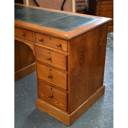 285 - A Victorian style oak and pine nine drawer pedestal desk, with leather skiver top, one drawer stampe... 