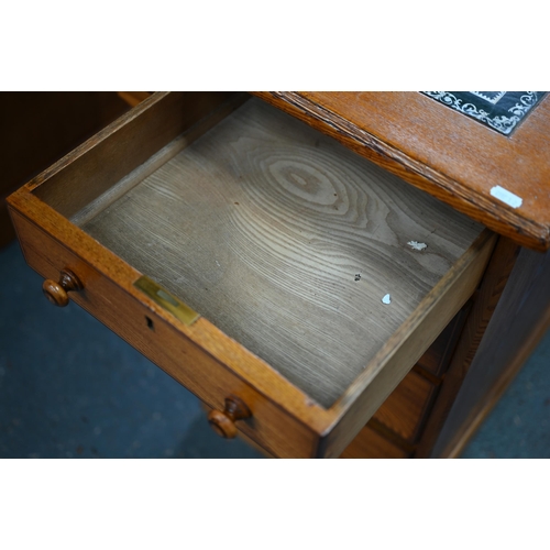 285 - A Victorian style oak and pine nine drawer pedestal desk, with leather skiver top, one drawer stampe... 