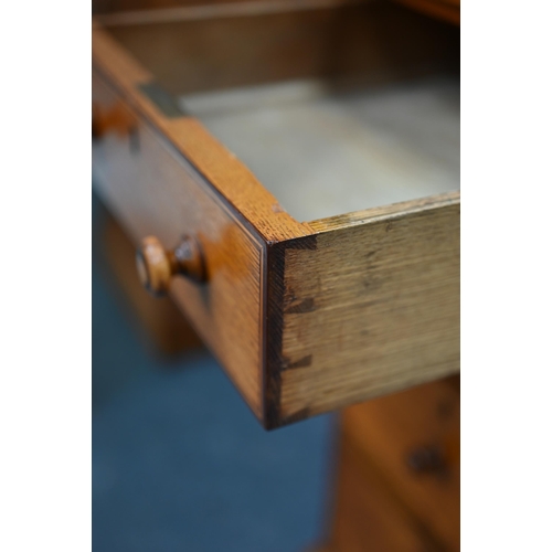 285 - A Victorian style oak and pine nine drawer pedestal desk, with leather skiver top, one drawer stampe... 