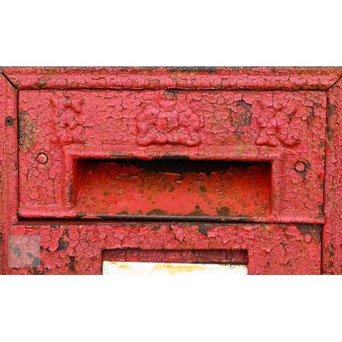 10 - A cast iron 'ER' branded mail box, wooden back, a/f