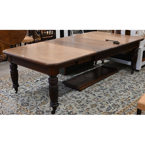 106 - A late 19th century mahogany extending dining table with four central leaves, on turned spiral reede... 