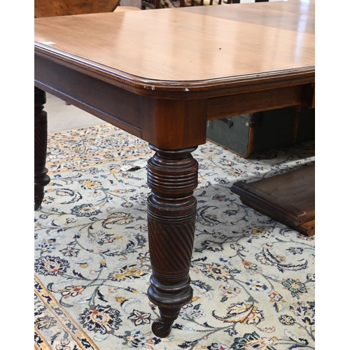 106 - A late 19th century mahogany extending dining table with four central leaves, on turned spiral reede... 