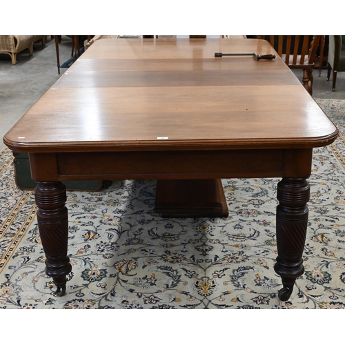 106 - A late 19th century mahogany extending dining table with four central leaves, on turned spiral reede... 