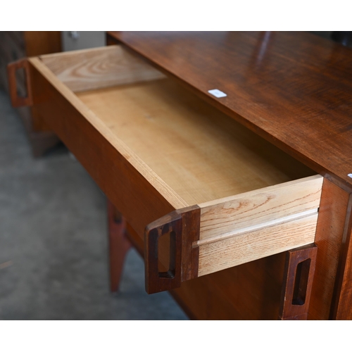 113 - A mid-century Danish influenced teak chest of four long drawers with pierced vertical strap handles ... 