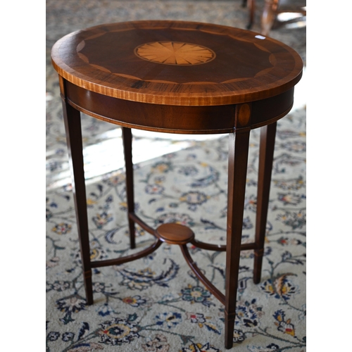 117 - A reproduction mahogany and rosewood banded oval occasional table with central inlaid fan patera, 58... 