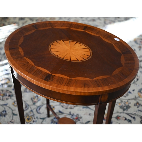 117 - A reproduction mahogany and rosewood banded oval occasional table with central inlaid fan patera, 58... 