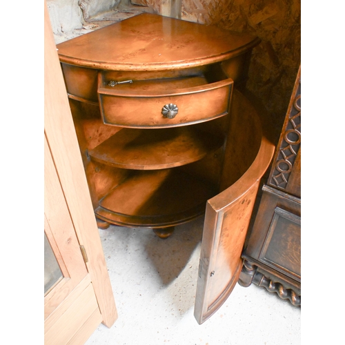 121 - A burr walnut veneer corner cabinet with single drawer over panelled cupboard and bun feet, 82 cm hi... 